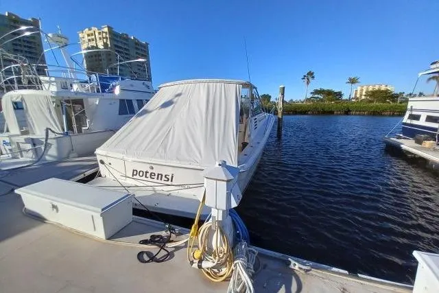 Slide: The Image of Engine compartment of a 1997 Sea Ray 370 Express Cruiser with visible components. - 64