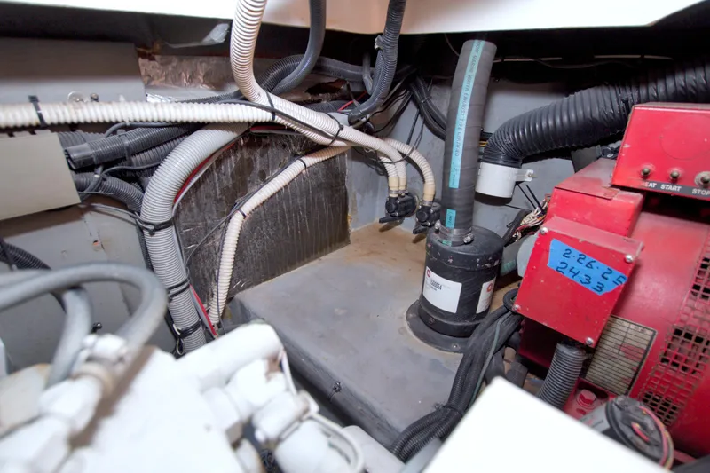 Slide: The Image of Engine room of a 1997 Sea Ray 370 Express Cruiser with visible wiring and machinery. - 67