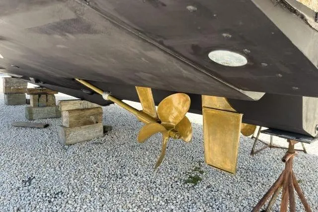Slide: The Image of Underneath view of a 1997 Sea Ray 370 Express Cruiser with visible propeller and rudder. - 73