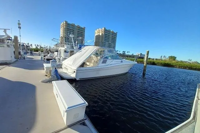 Slide: The Image of 1997 Sea Ray 370 Express Cruiser docked at marina with clear blue sky. - 76