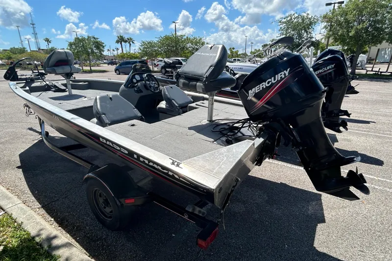 Slide: The Image of 2010 Tracker Pro Crappie 175 boat with Mercury outboard motor in parking lot. - 2