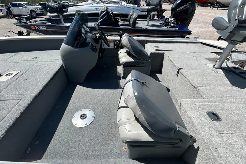 Slide: The Image of 2010 Tracker Pro Crappie 175 boat interior with gray seating and steering console. - 7