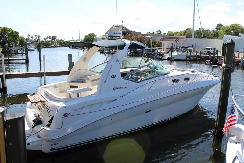 The Image of 2005 Sea Ray Sundancer 320 docked at marina, showcasing sleek design and spacious deck. - 0