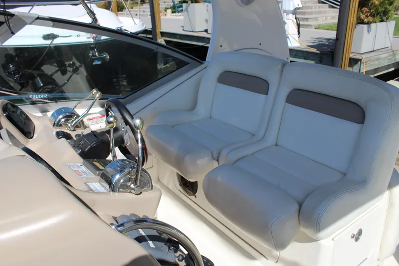 Slide: The Image of 2005 Sea Ray Sundancer 320 boat deck with railing, docked by the water. - 14