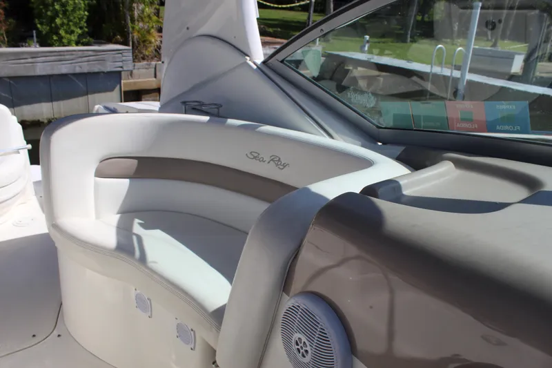 Slide: The Image of 2005 Sea Ray Sundancer 320 docked, showcasing sleek design and spacious cockpit. - 16