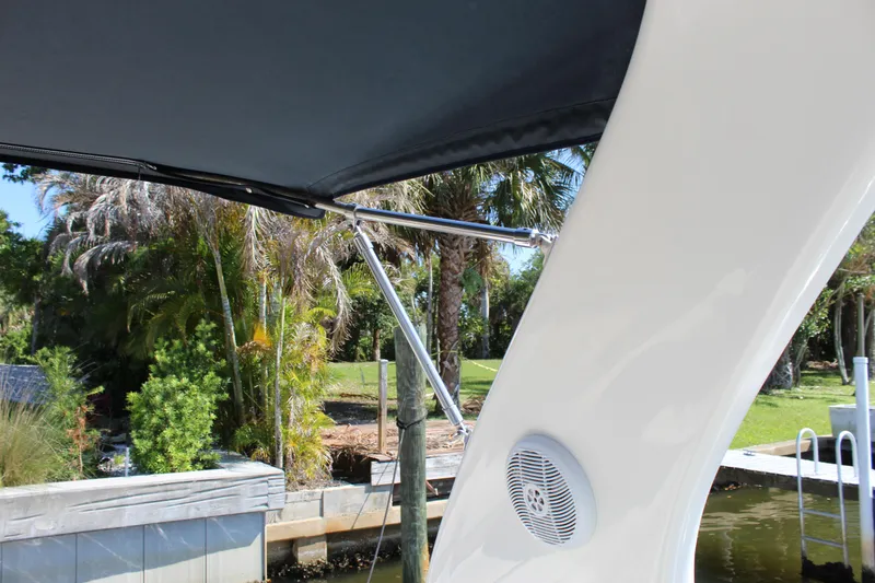 Slide: The Image of 2005 Sea Ray Sundancer 320 docked, showcasing sleek design and spacious deck area. - 17