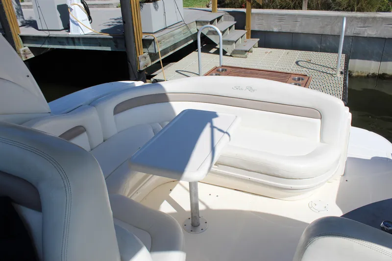 Slide: The Image of 2005 Sea Ray Sundancer 320 docked near lush greenery and modern building. - 18