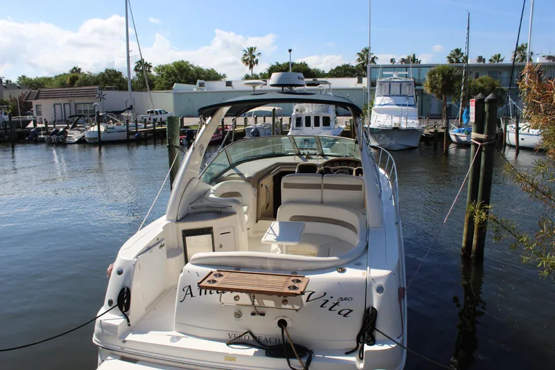 Slide: The Image of 2005 Sea Ray Sundancer 320 boat interior with white seating and speaker. - 20
