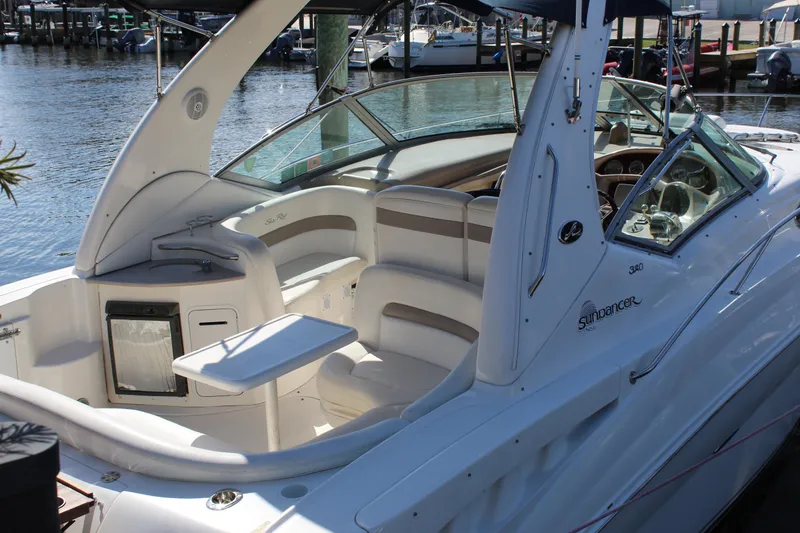 Slide: The Image of 2005 Sea Ray Sundancer 320 boat deck with white seating and water view. - 26