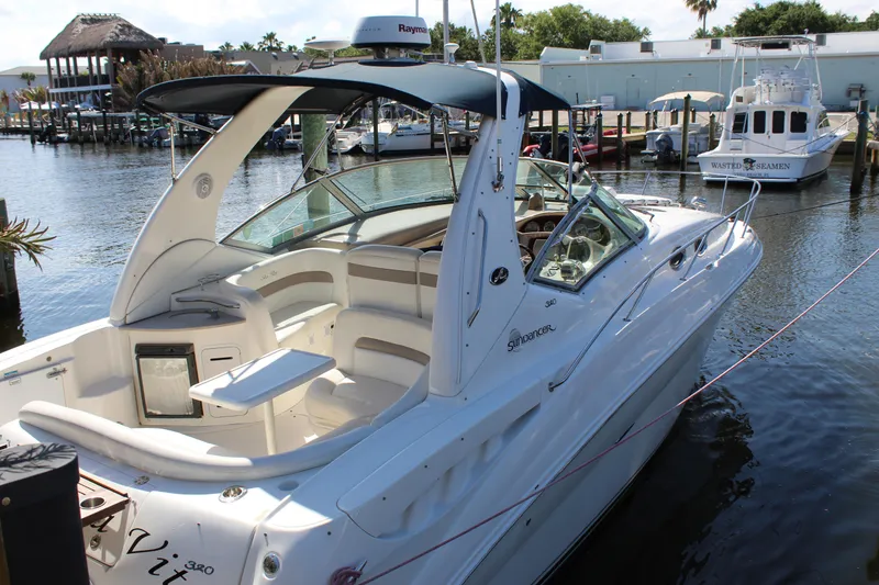 Slide: The Image of 2005 Sea Ray Sundancer 320 boat with wooden drink holder, docked near a platform. - 27