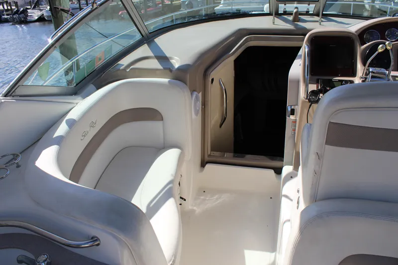 Slide: The Image of 2005 Sea Ray Sundancer 320 yacht docked, featuring spacious seating and elegant design. - 3
