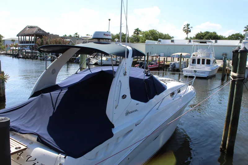 Slide: The Image of 2005 Sea Ray Sundancer 320 docked at a marina, covered with a blue tarp. - 30