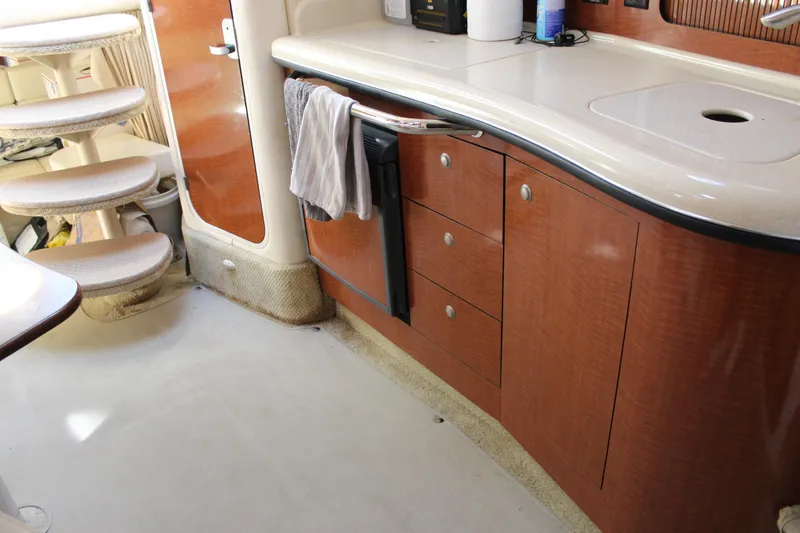 Slide: The Image of Interior of a 2005 Sea Ray Sundancer 320 yacht, featuring a compact kitchen area. - 34