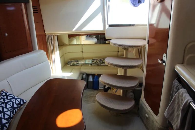 Slide: The Image of Interior of 2005 Sea Ray Sundancer 320 yacht with cozy seating and elegant wooden table. - 36