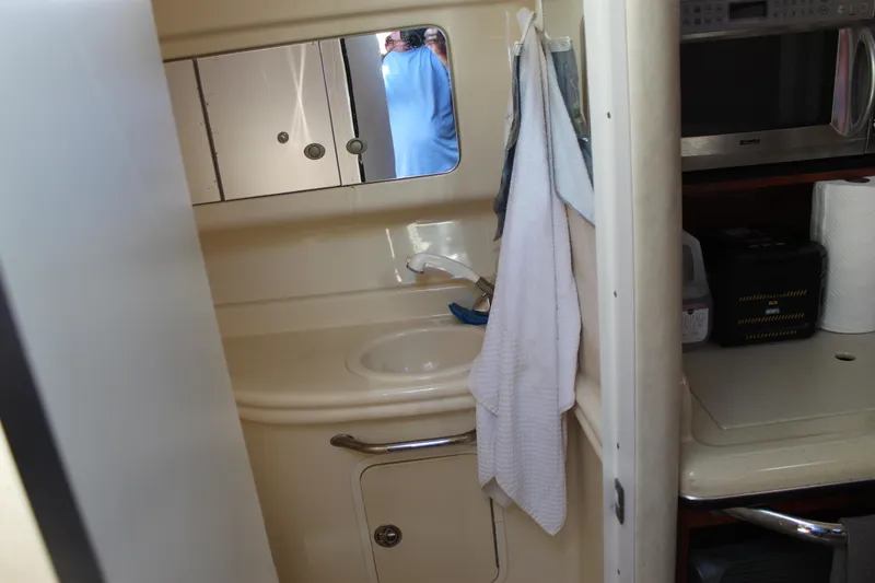 Slide: The Image of Interior of 2005 Sea Ray Sundancer 320 showing bathroom sink and kitchenette area. - 37