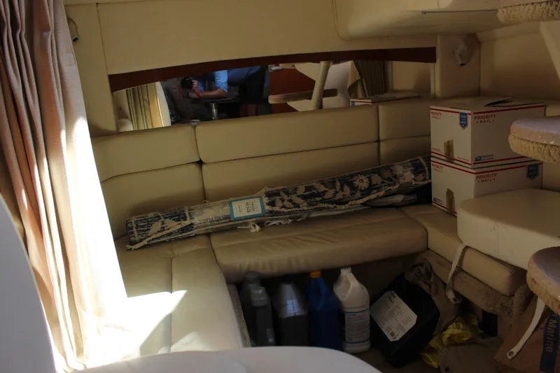 Slide: The Image of Interior of 2005 Sea Ray Sundancer 320 with seating, boxes, and cleaning supplies. - 39