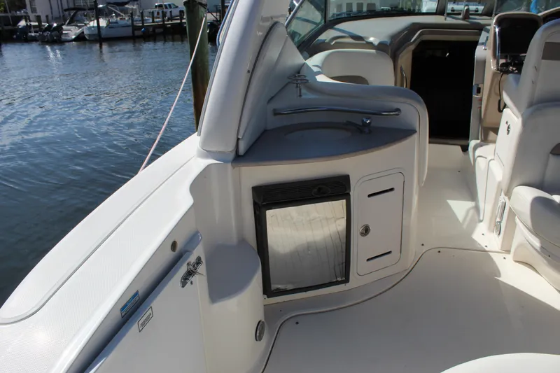 Slide: The Image of 2005 Sea Ray Sundancer 320 boat interior with seating and table, docked at marina. - 4