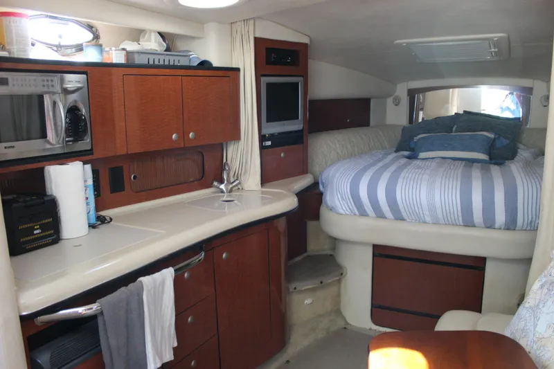 Slide: The Image of Interior of 2005 Sea Ray Sundancer 320 with kitchenette and cozy sleeping area. - 40