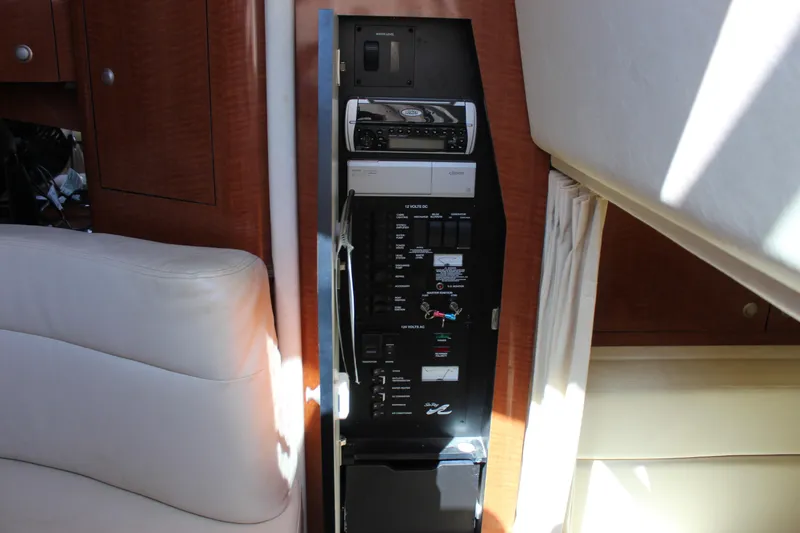 Slide: The Image of Control panel inside 2005 Sea Ray Sundancer 320 yacht, featuring various switches and controls. - 41
