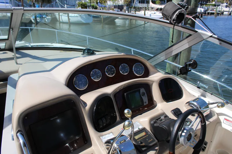 Slide: The Image of 2005 Sea Ray Sundancer 320 yacht interior with seating and helm, docked at marina. - 5