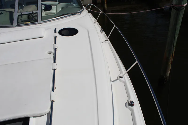 Slide: The Image of 2005 Sea Ray Sundancer 320 boat interior with sink and storage, docked by the water. - 9