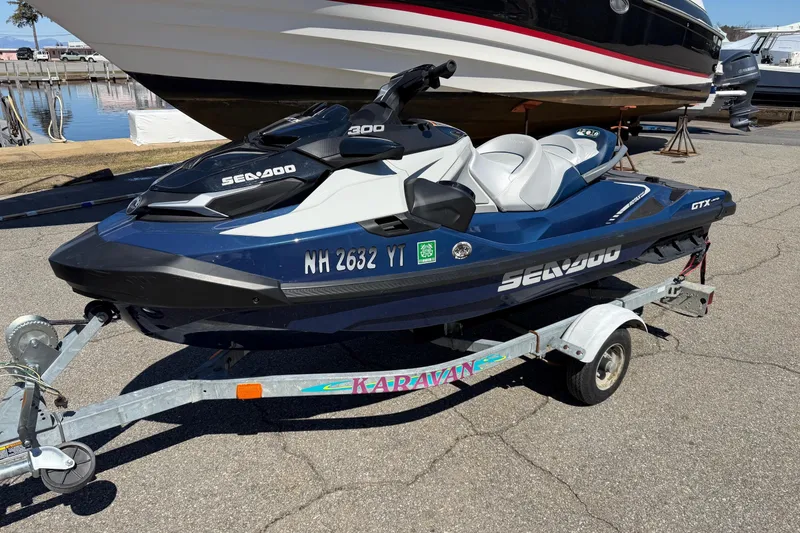 Slide: The Image of 2023 Sea-Doo GTX Limited 300 jet ski on trailer, parked near marina. - 5