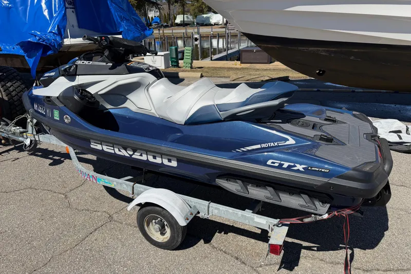 Slide: The Image of 2023 Sea-Doo GTX Limited 300 jet ski on trailer, parked outdoors. - 6