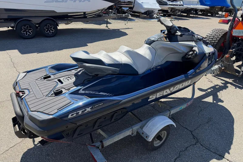 Slide: The Image of 2023 Sea-Doo GTX Limited 300 jet ski on trailer, parked outdoors. - 7