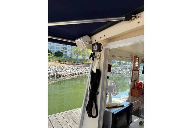 Slide: The Image of Cockpit view of a 1998 Rosborough RF-246 Sedan Cruiser, showing dockside and cabin details. - 11