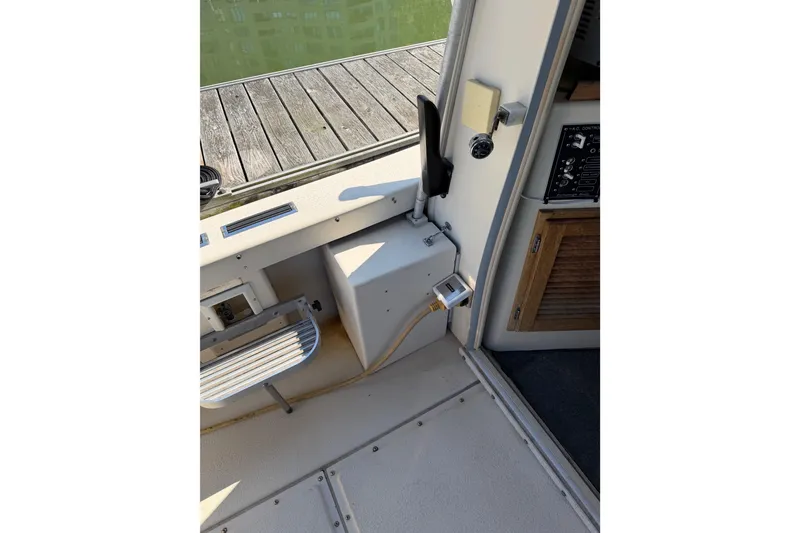 Slide: The Image of Port side cockpit step, propane tank storage, and shore power inlet - 12