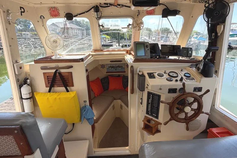 Slide: The Image of 1998 Rosborough RF-246 Sedan Cruiser interior with navigation equipment and cozy seating area. - 19