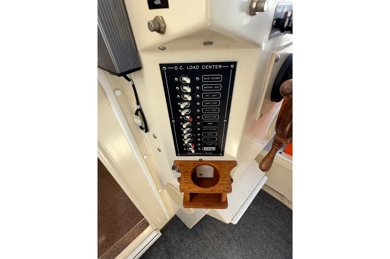 Slide: The Image of 1998 Rosborough RF-246 Sedan Cruiser DC load center panel with switches and wooden holder. - 25