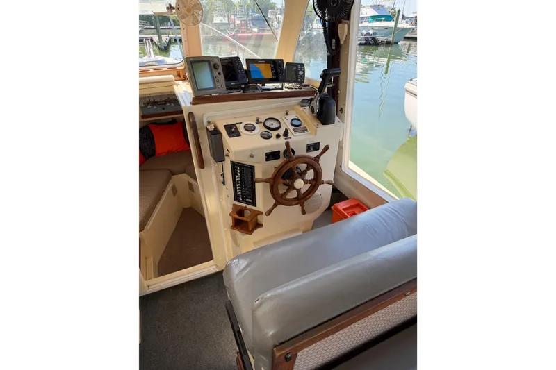 Slide: The Image of 1998 Rosborough RF-246 Sedan Cruiser helm with navigation equipment and wooden steering wheel. - 26