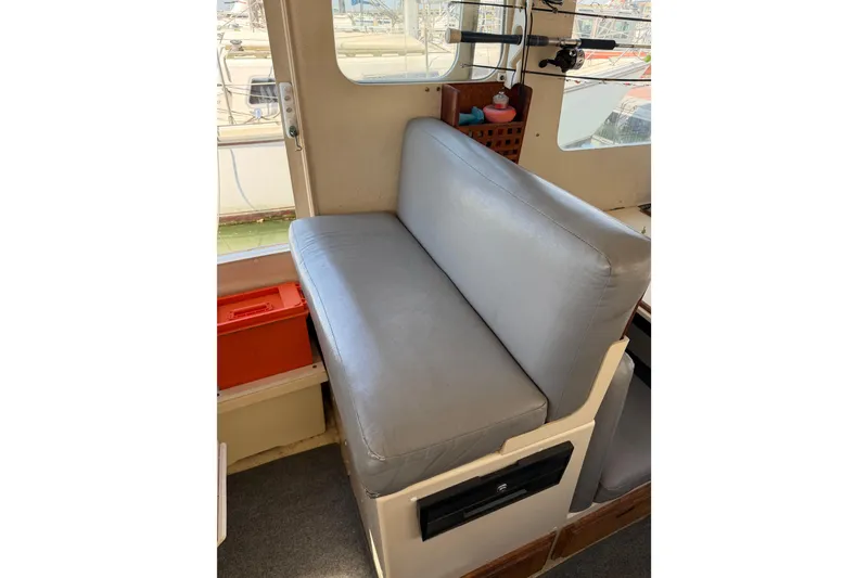 Slide: The Image of Interior seating of 1998 Rosborough RF-246 Sedan Cruiser with gray cushion and window view. - 30