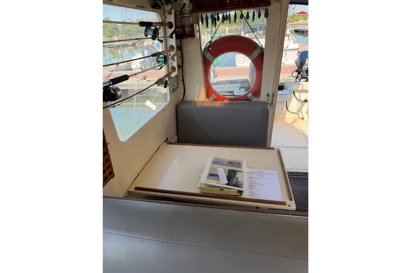 Slide: The Image of Interior of 1998 Rosborough RF-246 Sedan Cruiser with fishing rods and safety equipment. - 31