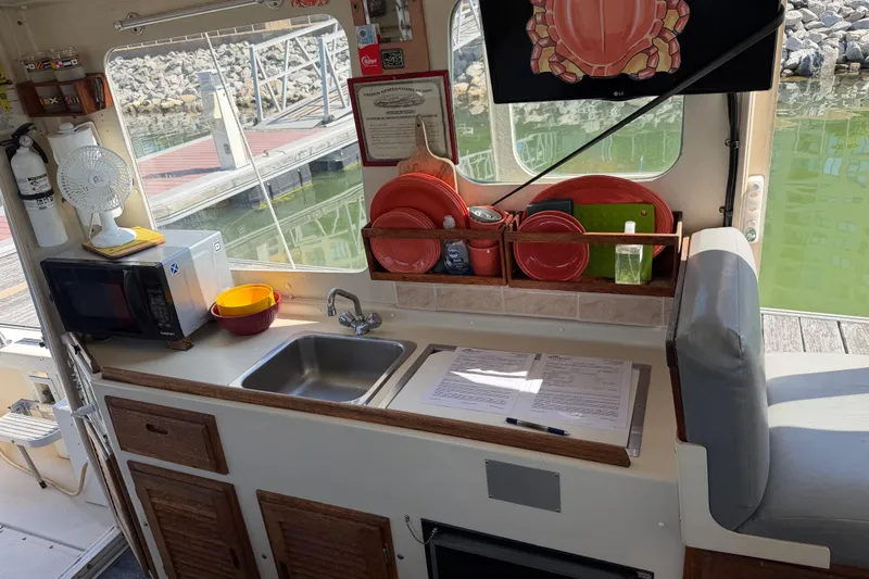 Slide: The Image of Interior of 1998 Rosborough RF-246 Sedan Cruiser with kitchenette and dockside view. - 32