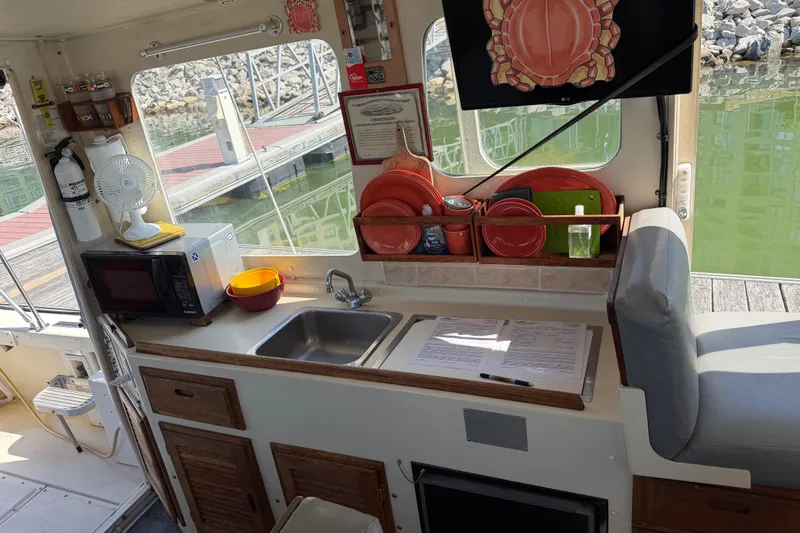 Slide: The Image of Interior of 1998 Rosborough RF-246 Sedan Cruiser with kitchenette and dockside view. - 33