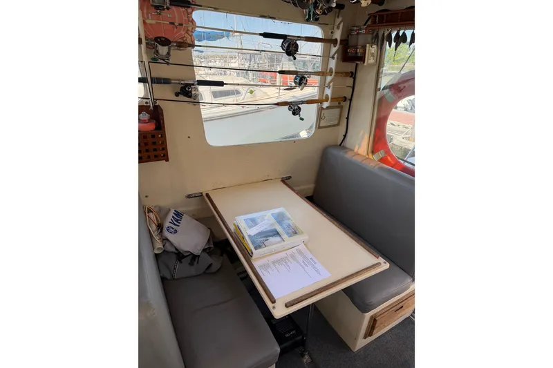 Slide: The Image of Interior of 1998 Rosborough RF-246 Sedan Cruiser with fishing rods and table setup. - 34
