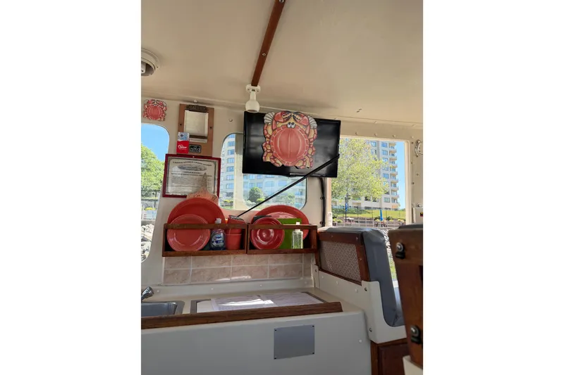 Slide: The Image of Interior of 1998 Rosborough RF-246 Sedan Cruiser with nautical decor, kitchenware, and Tv - 36