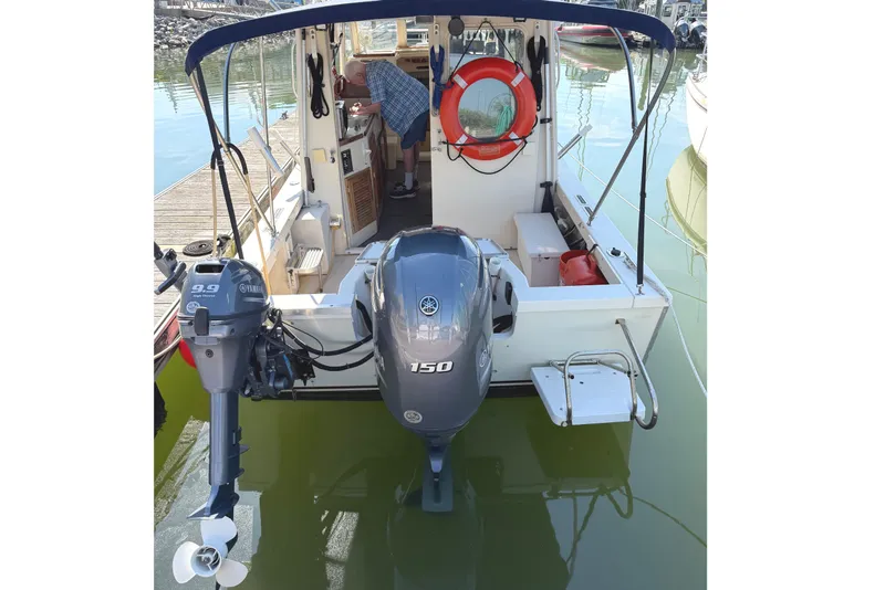 Slide: The Image of 1998 Rosborough RF-246 Sedan Cruiser with Yamaha outboard motors docked at marina. - 4