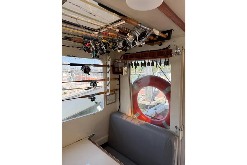 Slide: The Image of Interior of 1998 Rosborough RF-246 Sedan Cruiser with fishing rods and life preserver. - 41