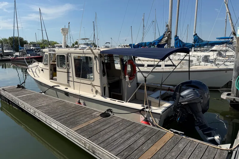 Slide: The Image of 1998 Rosborough RF-246 Sedan Cruiser docked at marina with Yamaha outboard motor. - 6