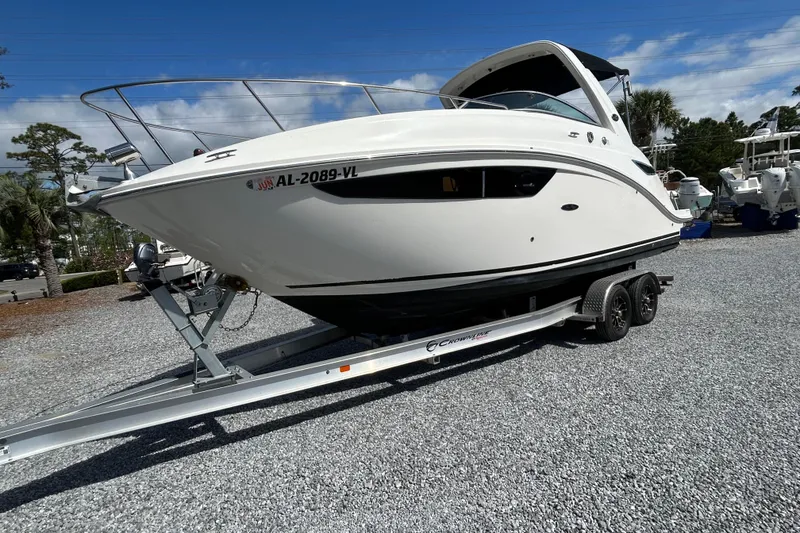 The Image of 2016 Sea Ray Sundancer 260 boat on trailer, parked on gravel lot. - 11