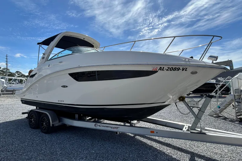 Slide: The Image of 2016 Sea Ray Sundancer 260 boat on trailer under clear blue sky. - 16