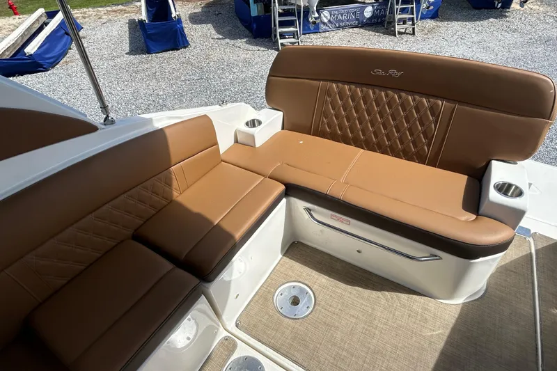 Slide: The Image of 2016 Sea Ray Sundancer 260 boat seating area with brown leather upholstery. - 19