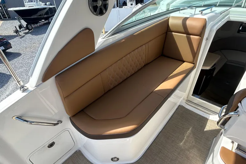 Slide: The Image of 2016 Sea Ray Sundancer 260 interior with brown leather seating and modern design. - 21
