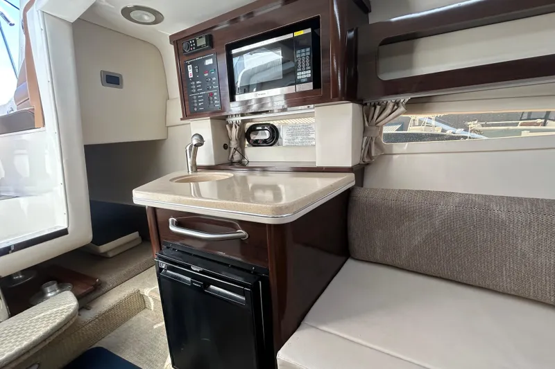 Slide: The Image of Interior of 2016 Sea Ray Sundancer 260 with kitchenette and seating area. - 27