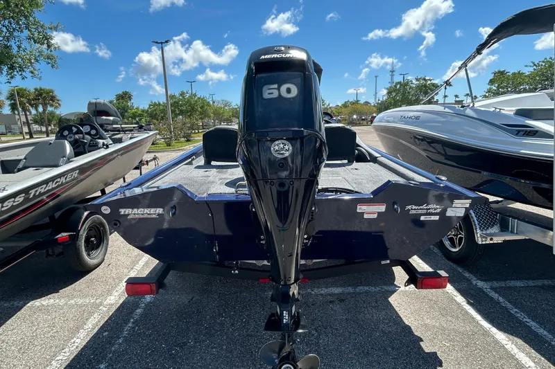 Slide: The Image of 2021 Tracker Pro Team 175 TF boat with Mercury 60 engine in parking lot. - 2
