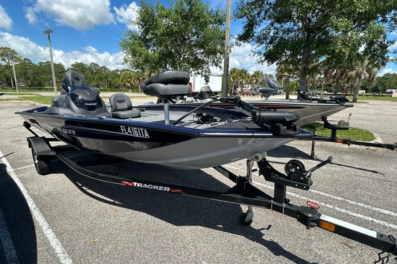 Slide: The Image of 2021 Tracker Pro Team 175 TF fishing boat on trailer in sunny parking lot. - 4