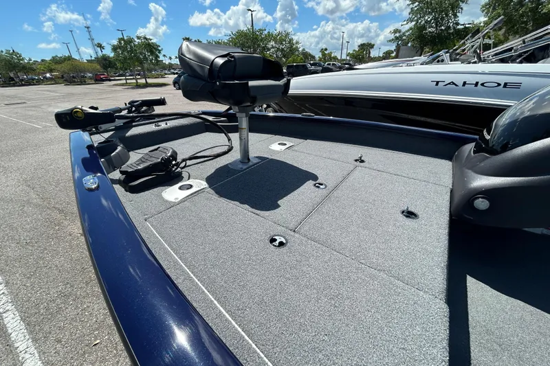 Slide: The Image of 2021 Tracker Pro Team 175 TF boat with fishing deck and seat, parked outdoors. - 6